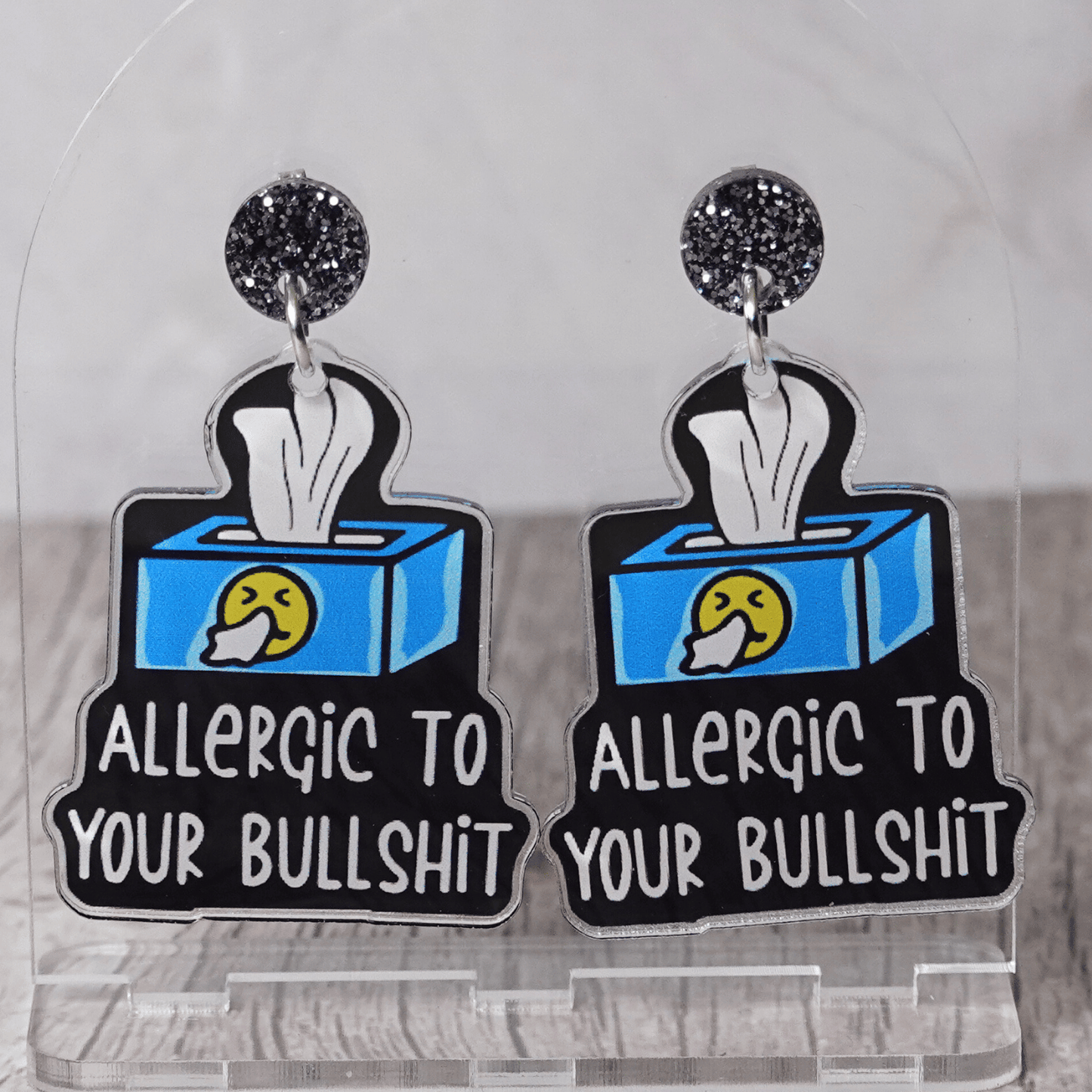 Acrylic dangle earrings shaped like a tissue box with text reading “Allergic to your bullshit”