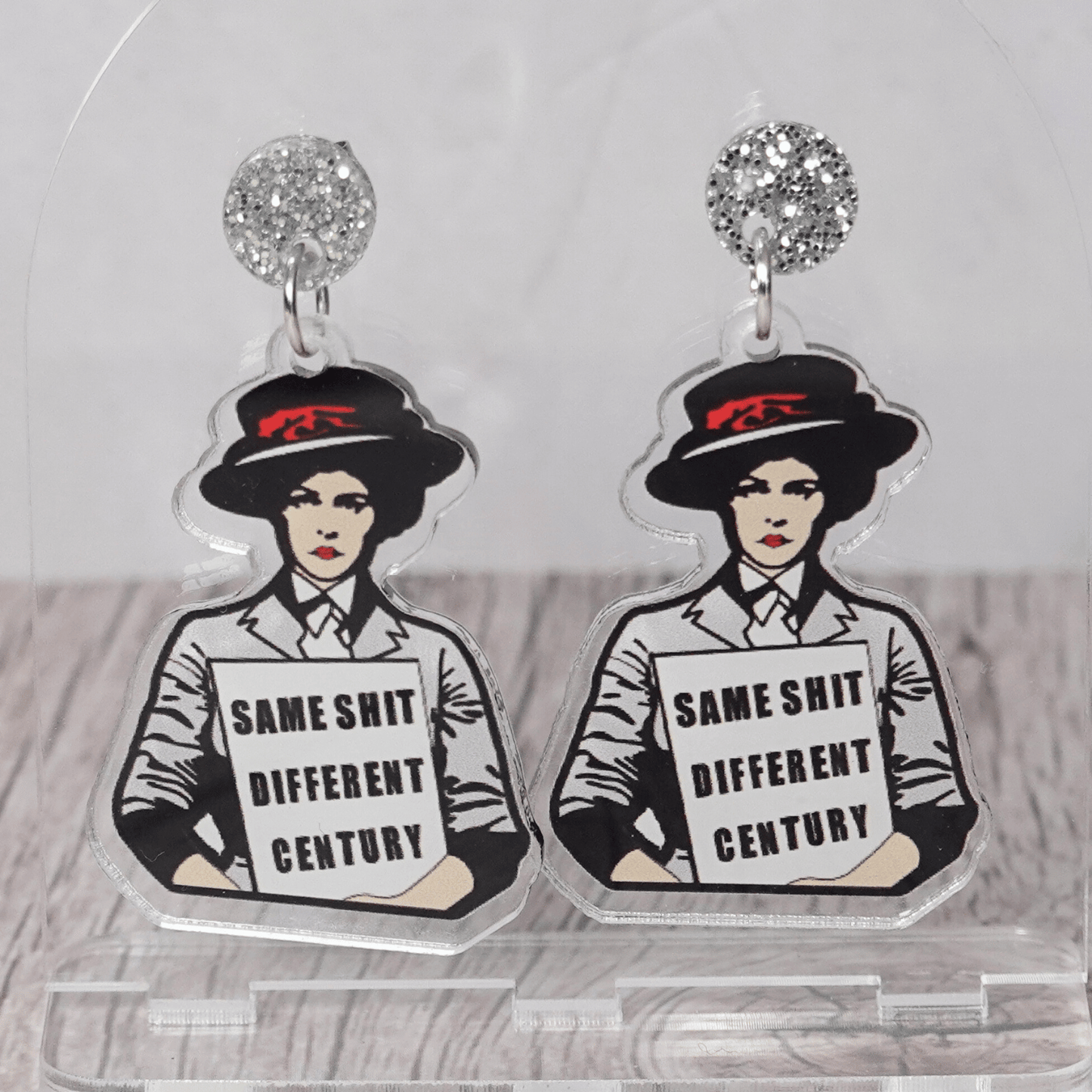 Funny acrylic dangle earrings featuring a vintage-style woman holding a sign that reads “Same shit different century.”