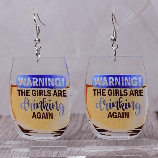 Wine glass dangle earrings with text “warning the girls are drinking again”