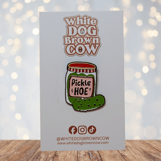 Cute enamel pin of a pickle jar labeled “Pickle Hoe” with green pickle illustration, funny food pun lapel pin.