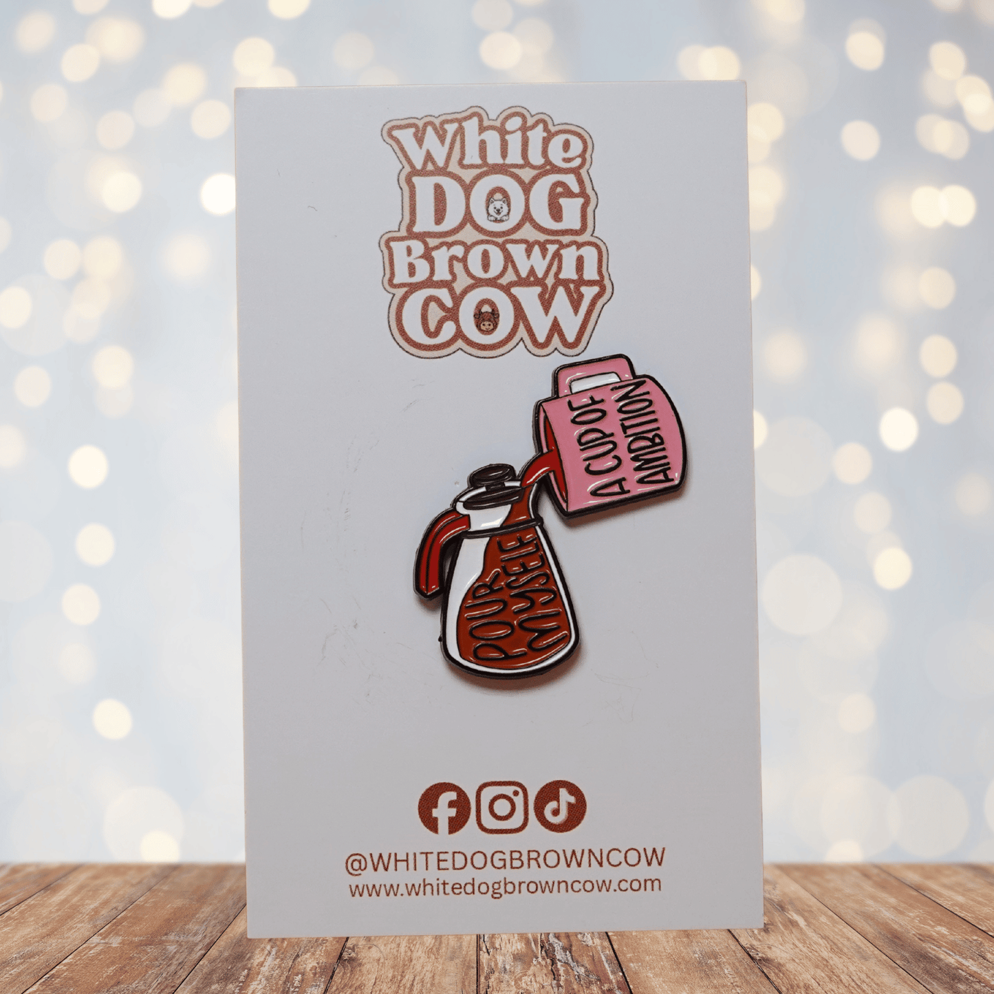 Enamel pin of coffee pot pouring into pink mug reading “A Cup of Ambition” with text “Pour Myself,” funny motivational Dolly Parton inspired lapel pin.