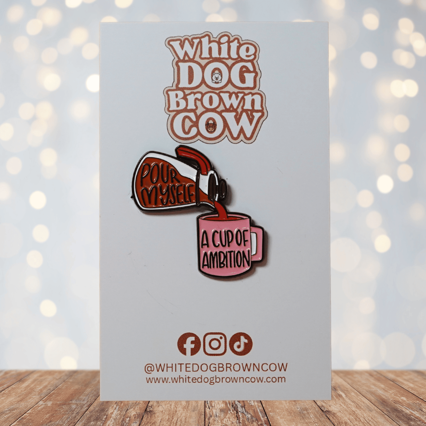 Enamel pin of coffee pot pouring into pink mug reading “A Cup of Ambition” with text “Pour Myself,” funny motivational Dolly Parton inspired lapel pin.