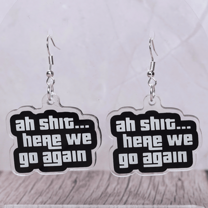Black and white novelty earrings with text “ah shit here we go again”