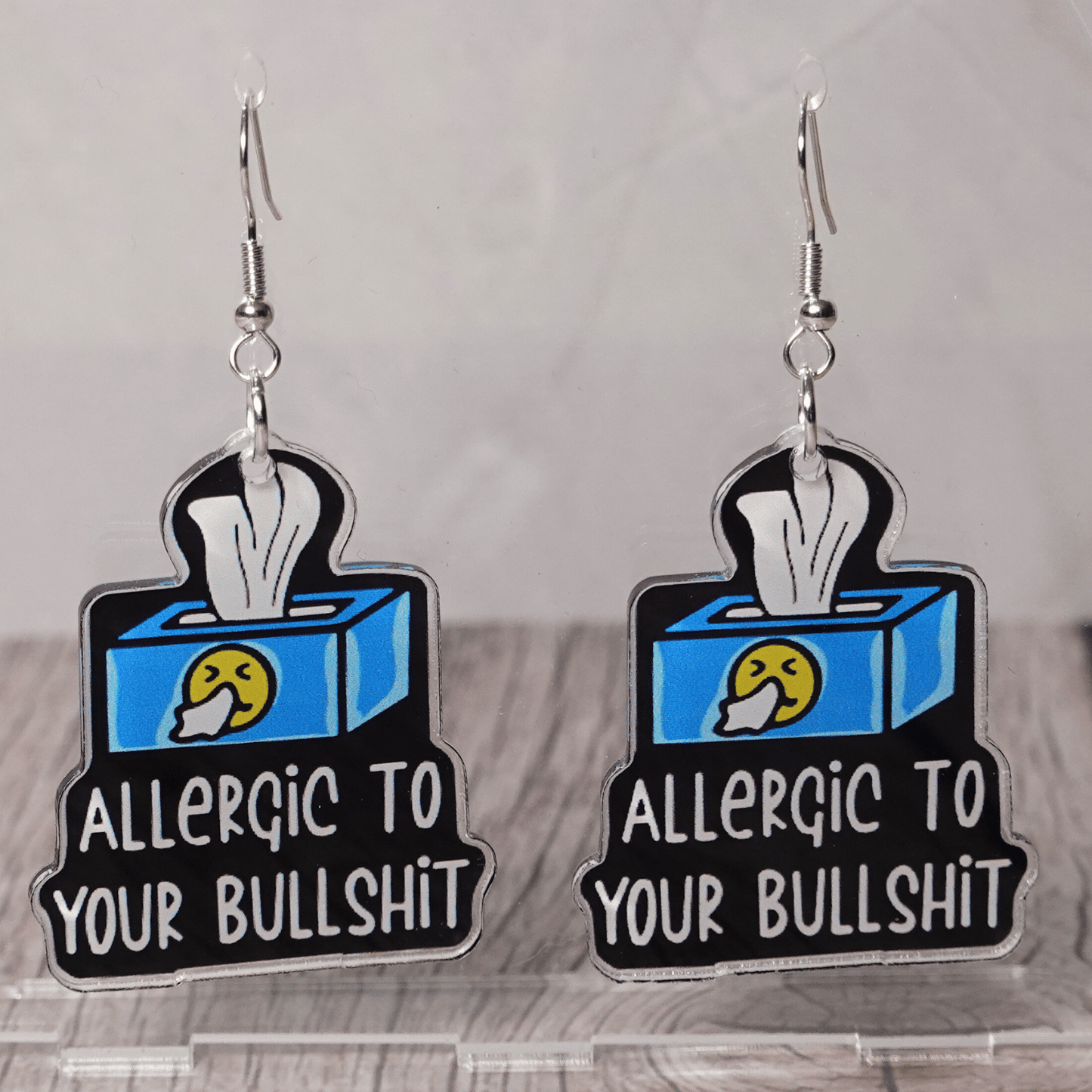 Acrylic dangle earrings shaped like a tissue box with text reading “Allergic to your bullshit”