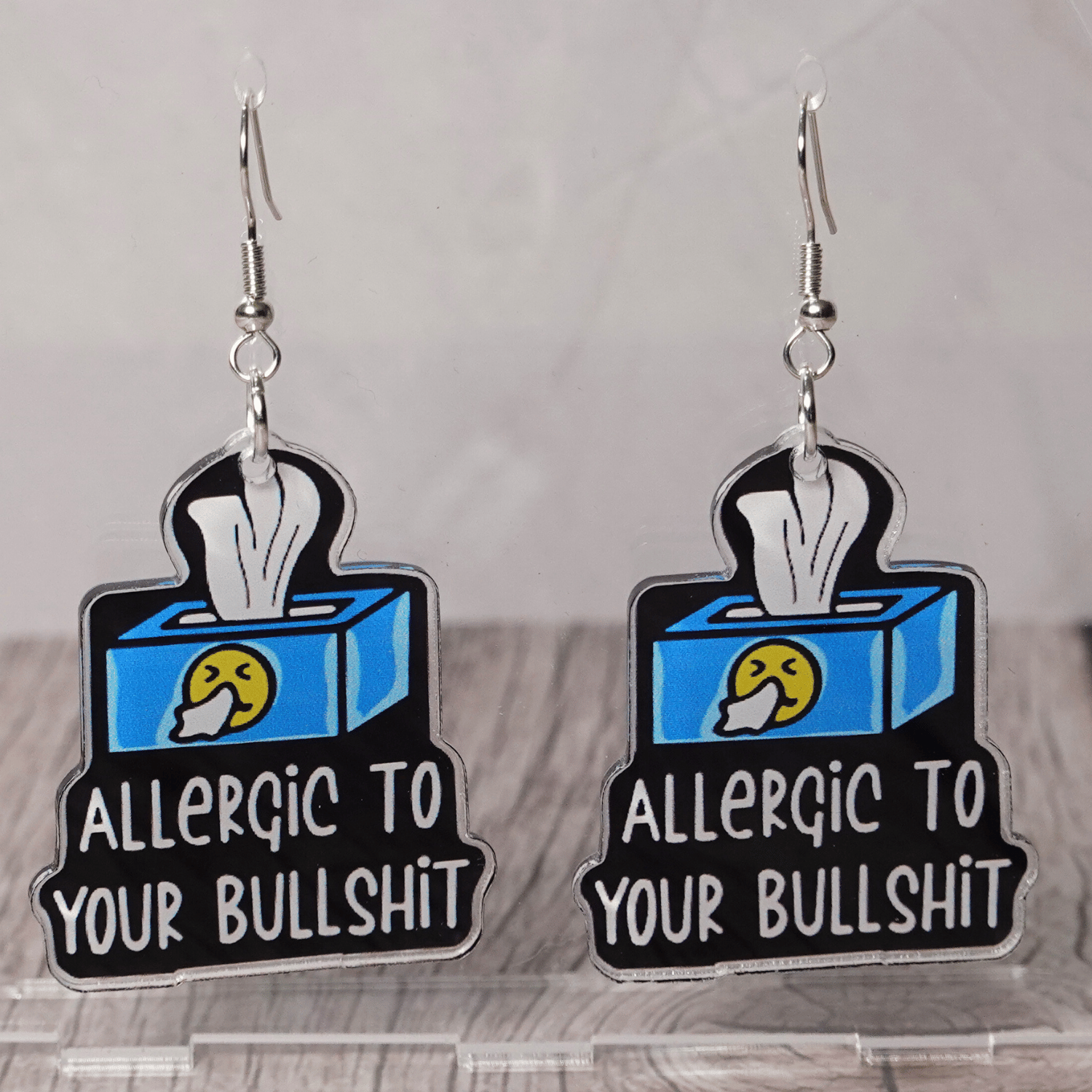 Acrylic dangle earrings shaped like a tissue box with text reading “Allergic to your bullshit”