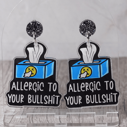 Acrylic dangle earrings shaped like a tissue box with text reading “Allergic to your bullshit”