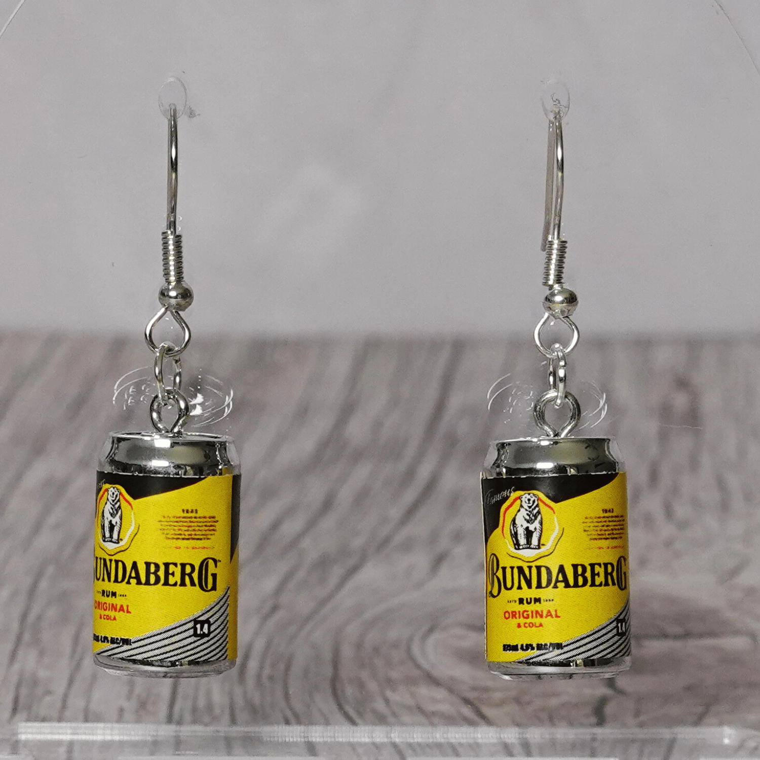 Novelty dangle earrings shaped like small rum and cola drink cans
