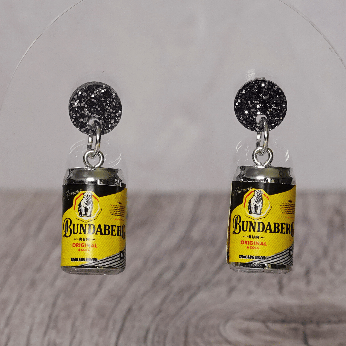 Novelty dangle earrings shaped like small rum and cola drink cans