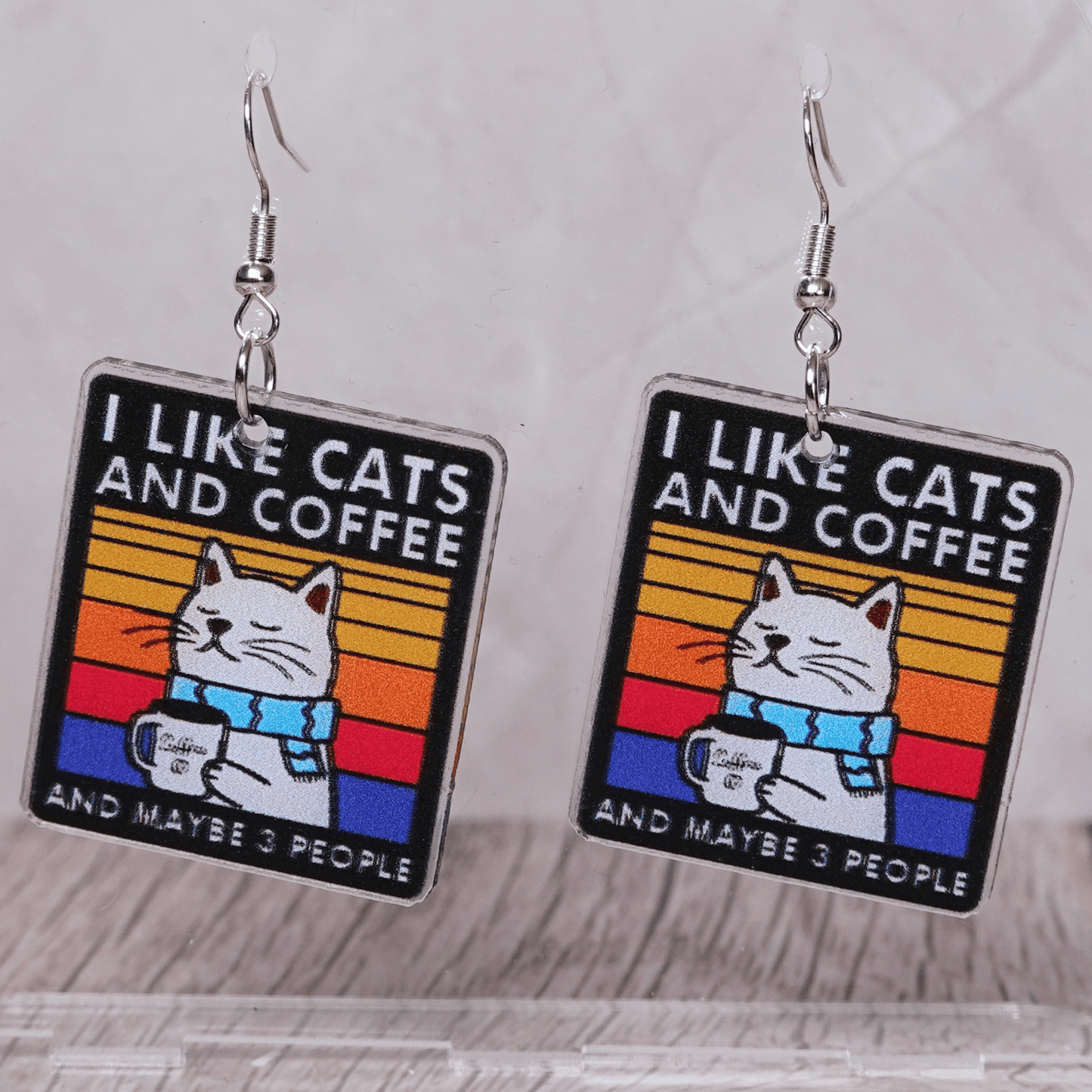 Square dangle earrings with cat holding coffee mug and text “I like cats and coffee and maybe 3 people”