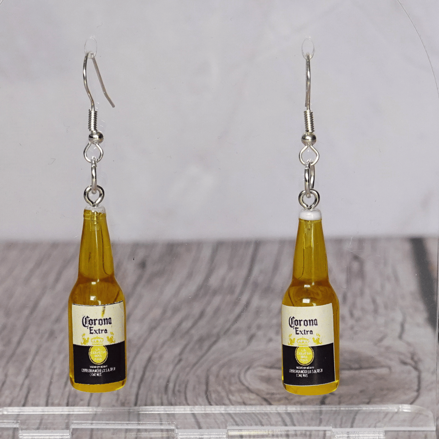 Novelty dangle earrings shaped like small beer bottles