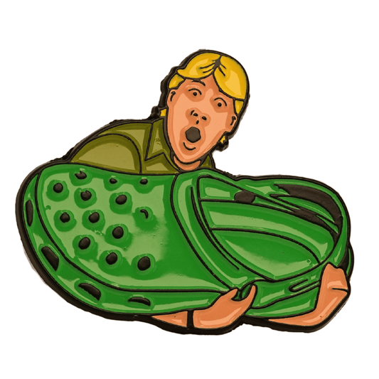 Funny enamel pin of Steve Irwin holding a giant green croc shoe, humorous novelty pin