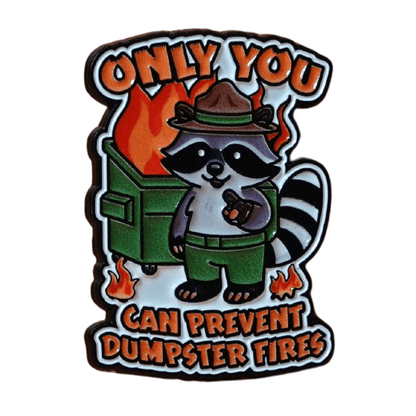 Funny raccoon enamel pin with burning dumpster design and quote “Only You Can Prevent Dumpster Fires,” sarcastic dark humor lapel pin.