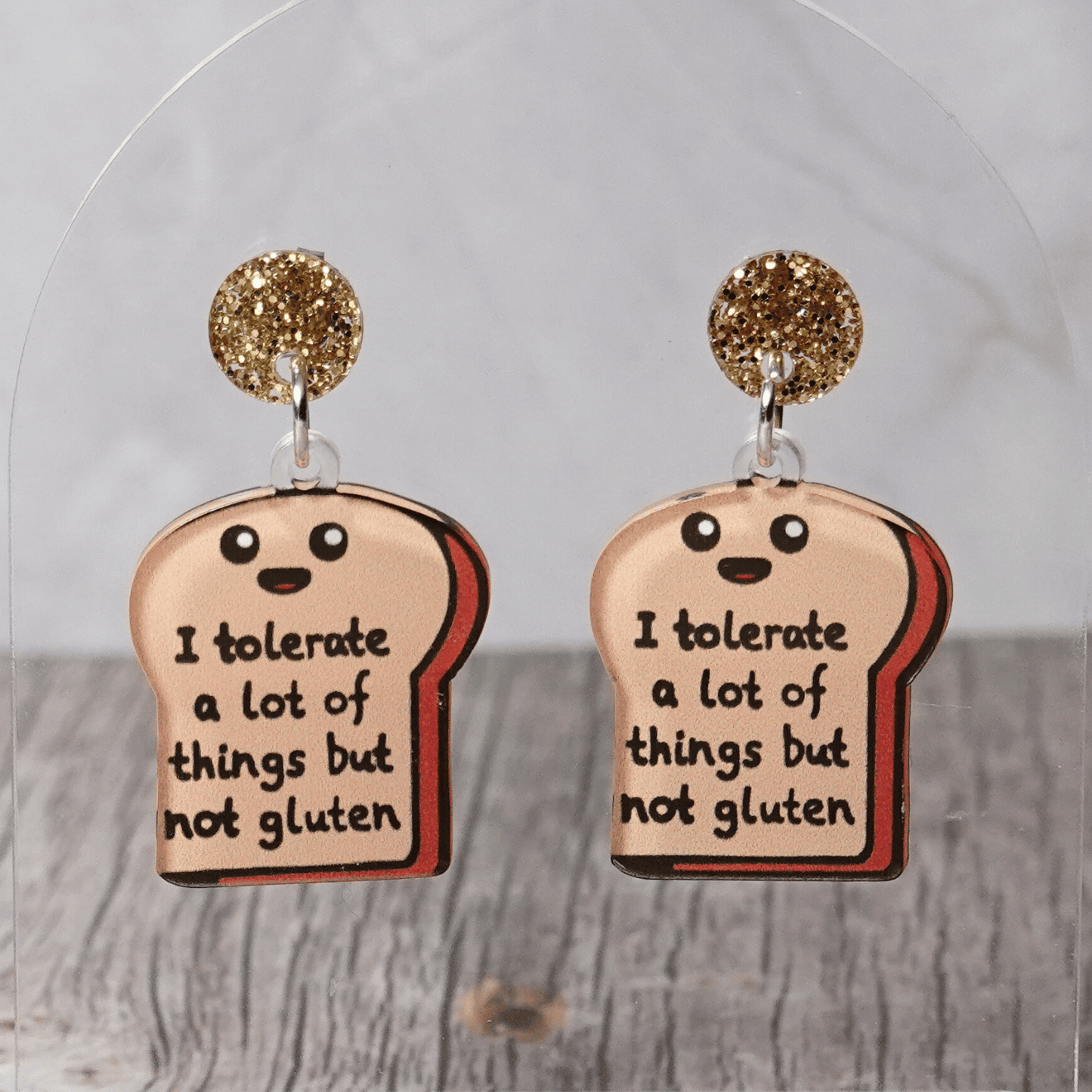 Acrylic dangle earrings shaped like a slice of bread with text reading “I tolerate a lot of things but not gluten”