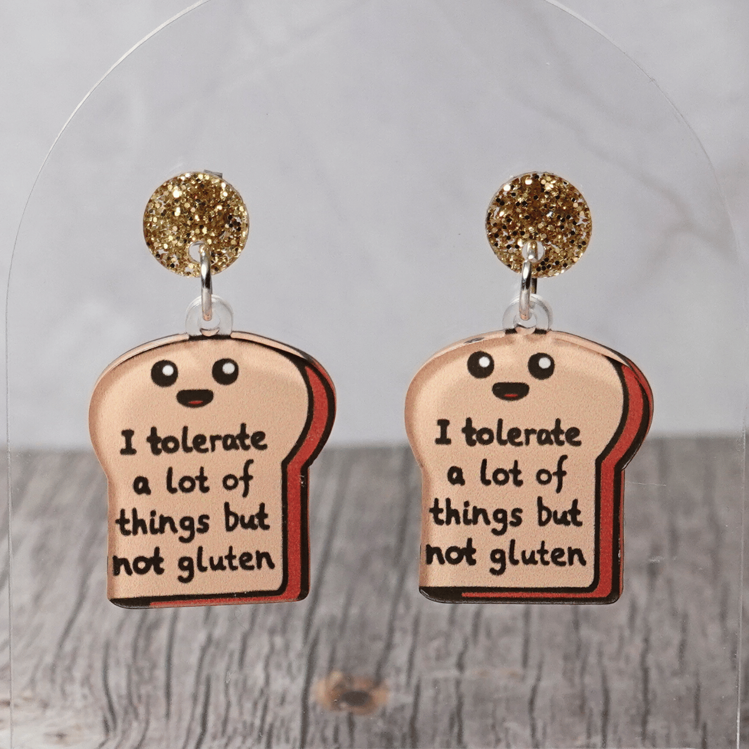 Acrylic dangle earrings shaped like a slice of bread with text reading “I tolerate a lot of things but not gluten”