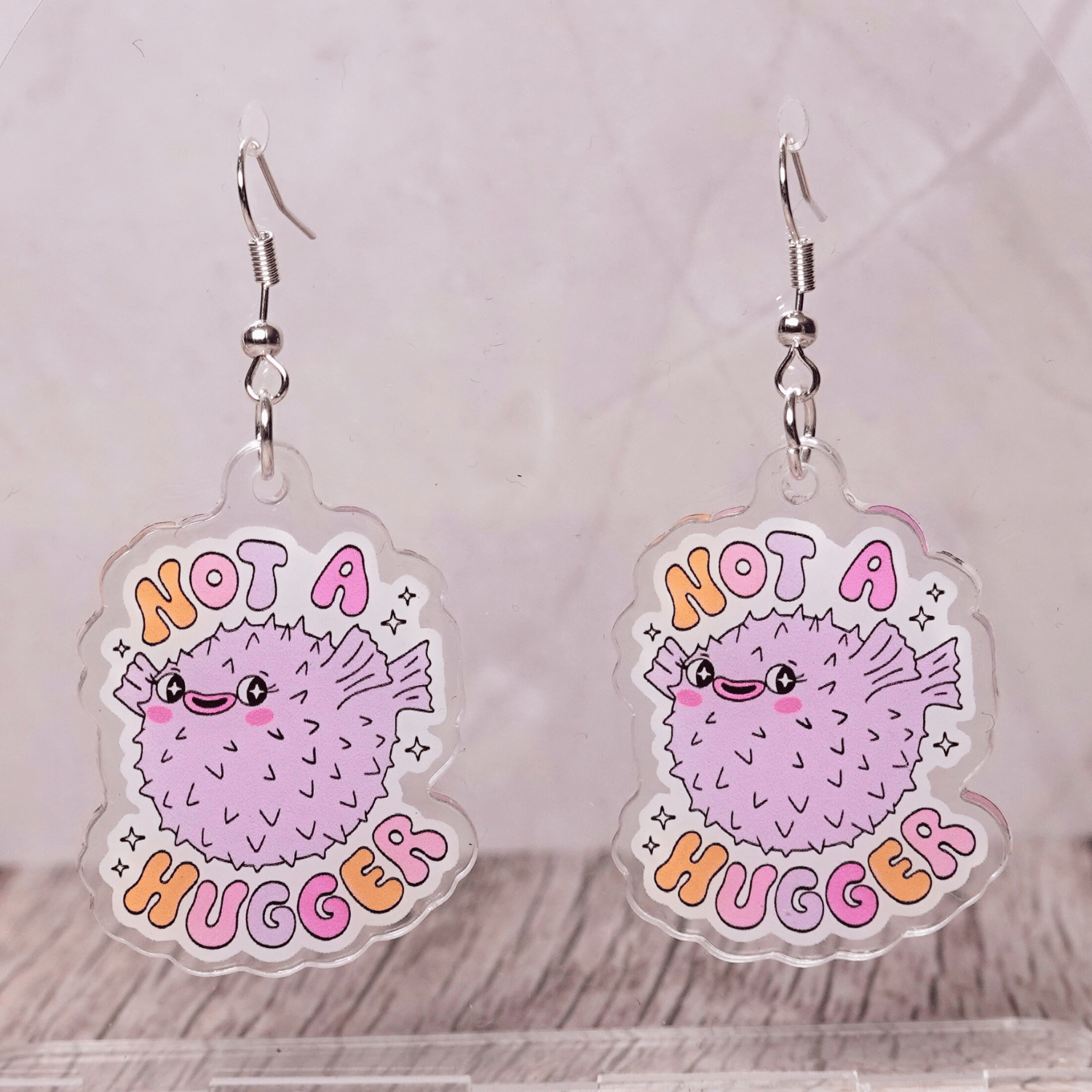 Cute pastel pufferfish dangle earrings with text “Not a Hugger”