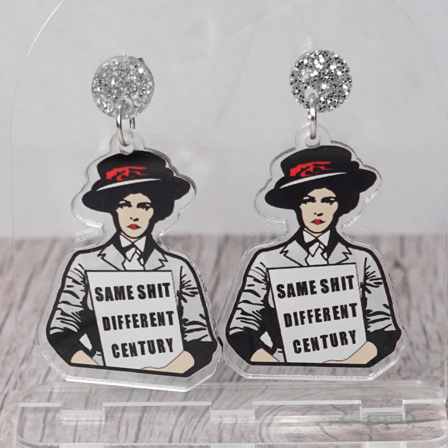 Funny acrylic dangle earrings featuring a vintage-style woman holding a sign that reads “Same shit different century.”