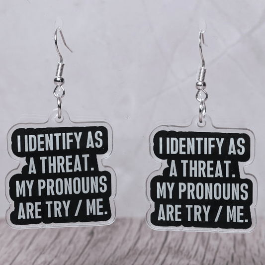 Black and white novelty earrings reading I identify as a threat my pronouns are try me