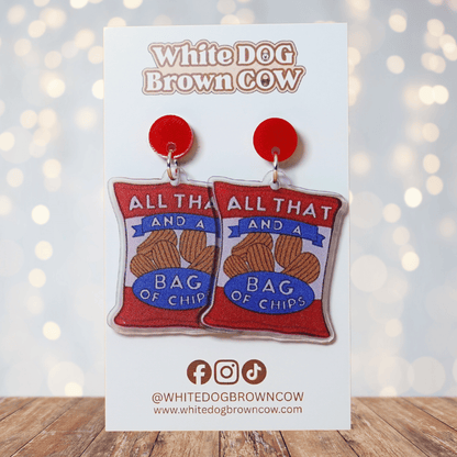 Funny acrylic dangle earrings shaped like a red chip bag that reads “All That and a Bag of Chips,” featuring illustrated potato chips and retro lettering.