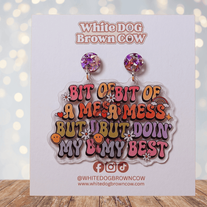 Colorful novelty dangle earrings with text “bit of a mess but doin’ my best”