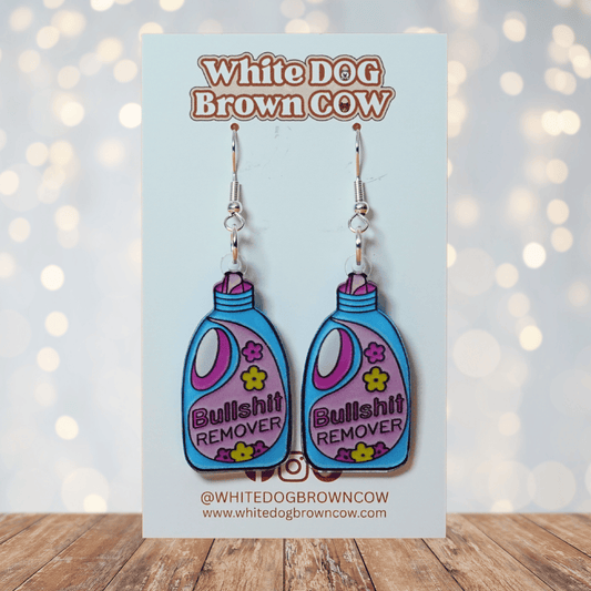 Colorful novelty dangle earrings shaped like a detergent bottle labeled “Bullsh*t remover”