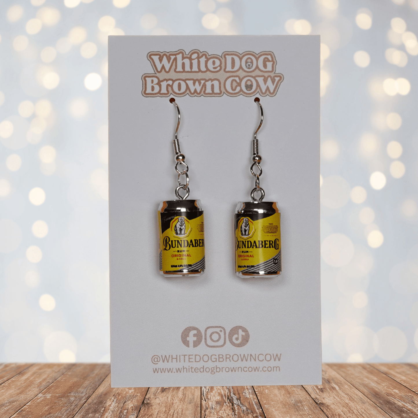 Novelty dangle earrings shaped like small rum and cola drink cans