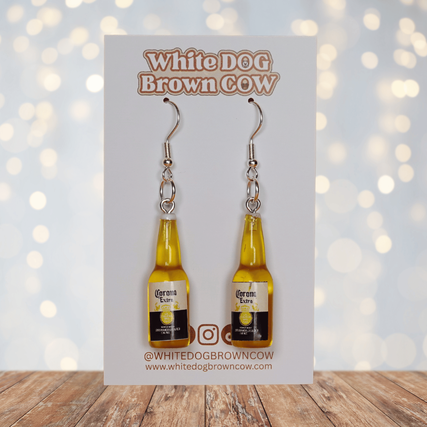 Novelty dangle earrings shaped like small beer bottles