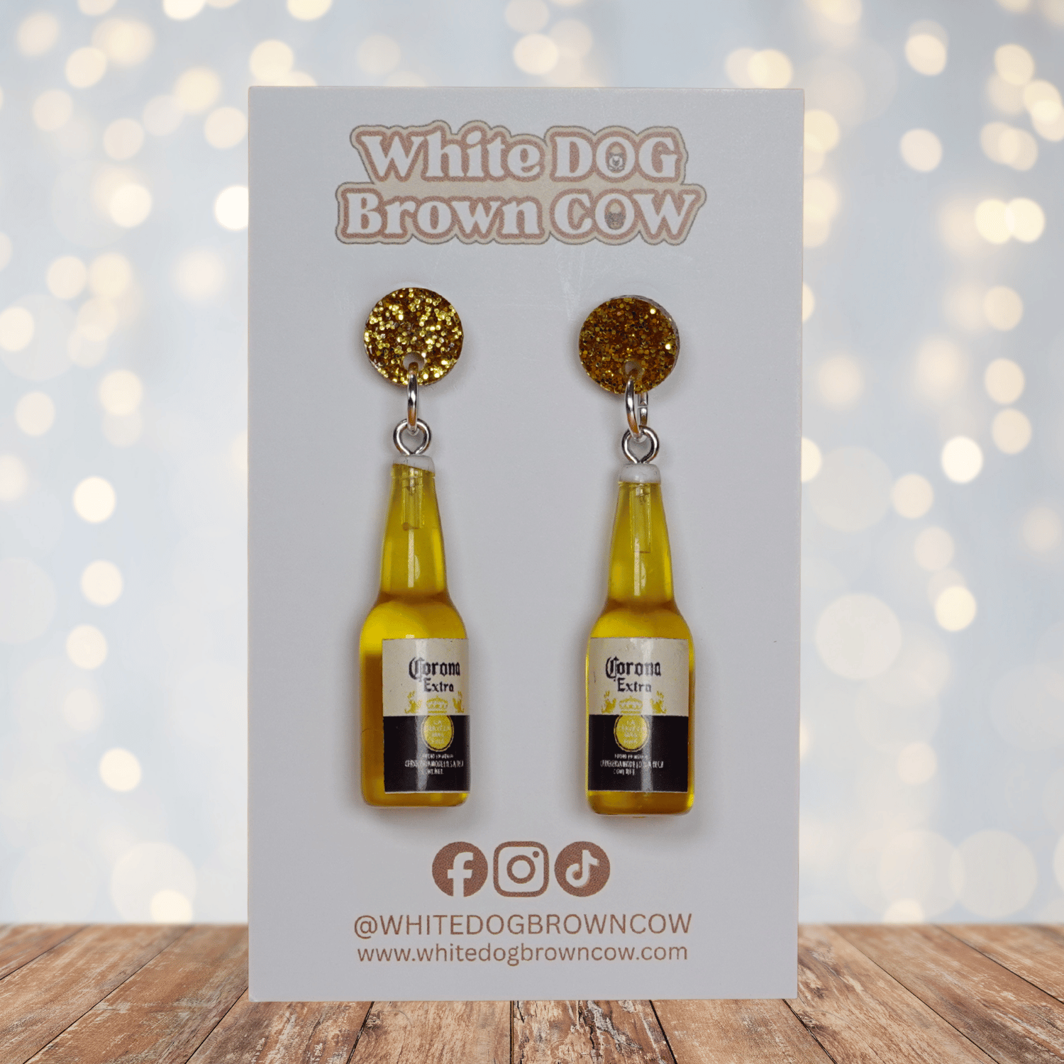 Novelty dangle earrings shaped like small beer bottles