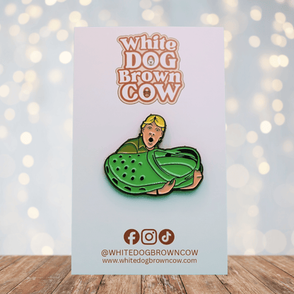 Funny enamel pin of Steve Irwin holding a giant green croc shoe, humorous novelty pin