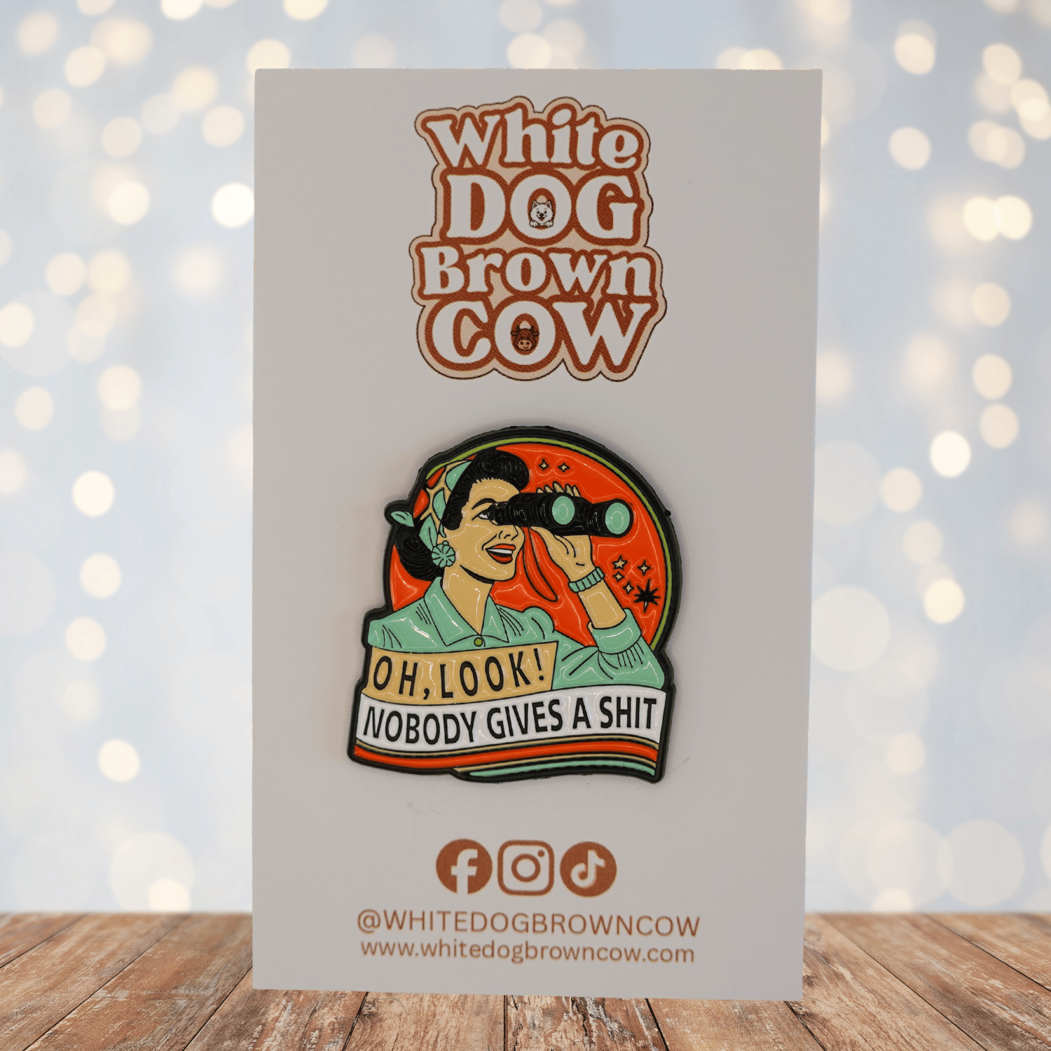 Funny sarcastic enamel pin with woman using binoculars and text “Oh look nobody gives a shit”