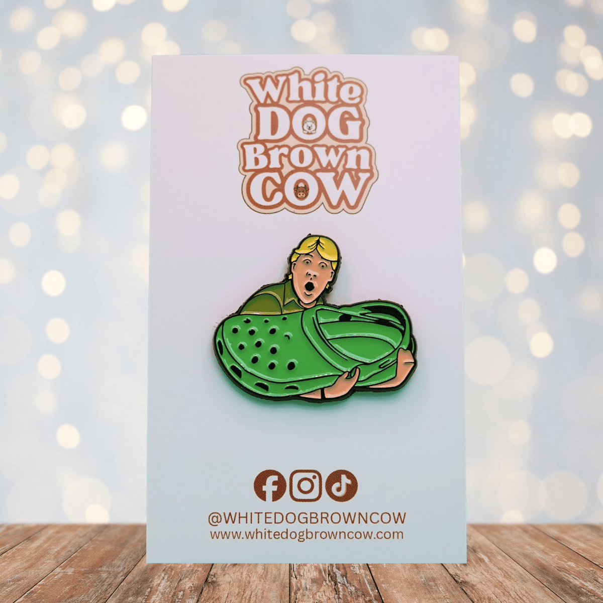 Funny enamel pin of Steve Irwin holding a giant green clog shoe, humorous novelty pin