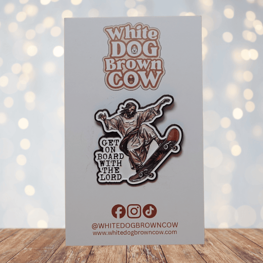 Enamel pin of Jesus riding a skateboard with the phrase “Get On Board With The Lord,” funny religious humor skateboarding lapel pin.