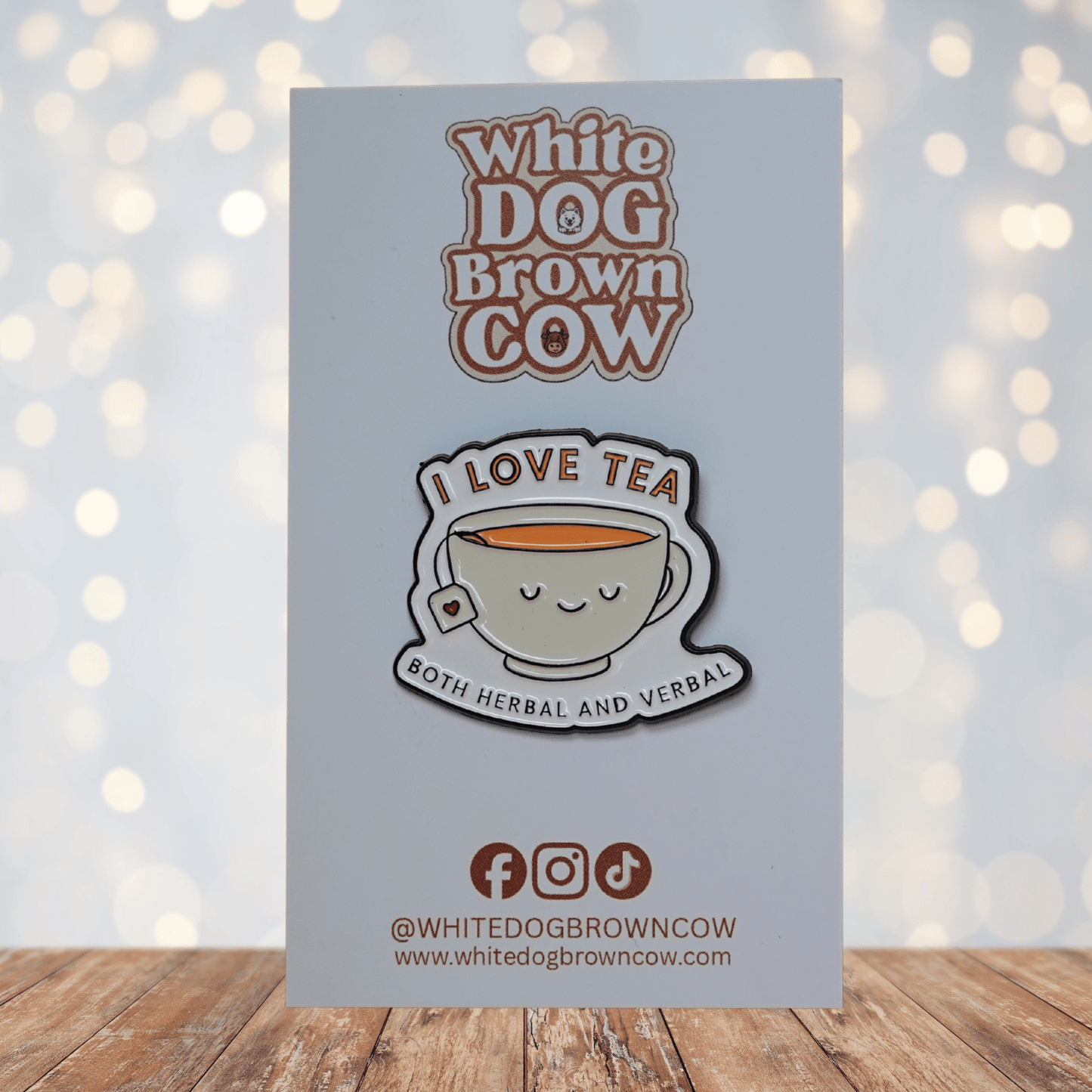 Funny enamel pin of a smiling teacup with tea bag and the phrase “I Love Tea – Both Herbal and Verbal,” sarcastic tea lover lapel pin gift.