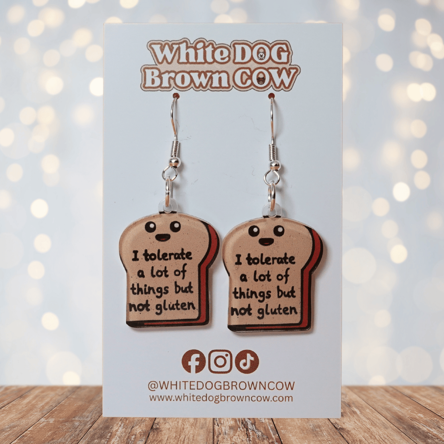 Acrylic dangle earrings shaped like a slice of bread with text reading “I tolerate a lot of things but not gluten”