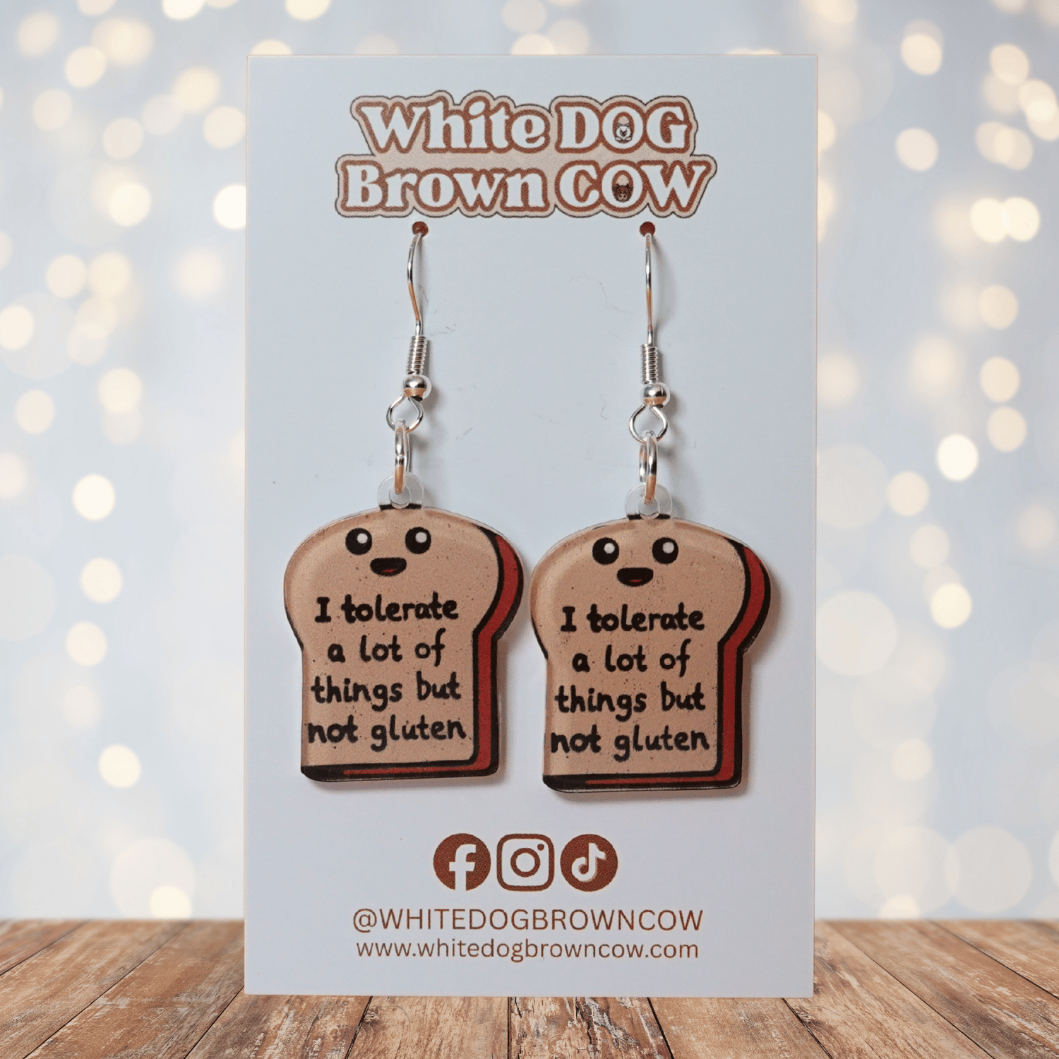 Acrylic dangle earrings shaped like a slice of bread with text reading “I tolerate a lot of things but not gluten”