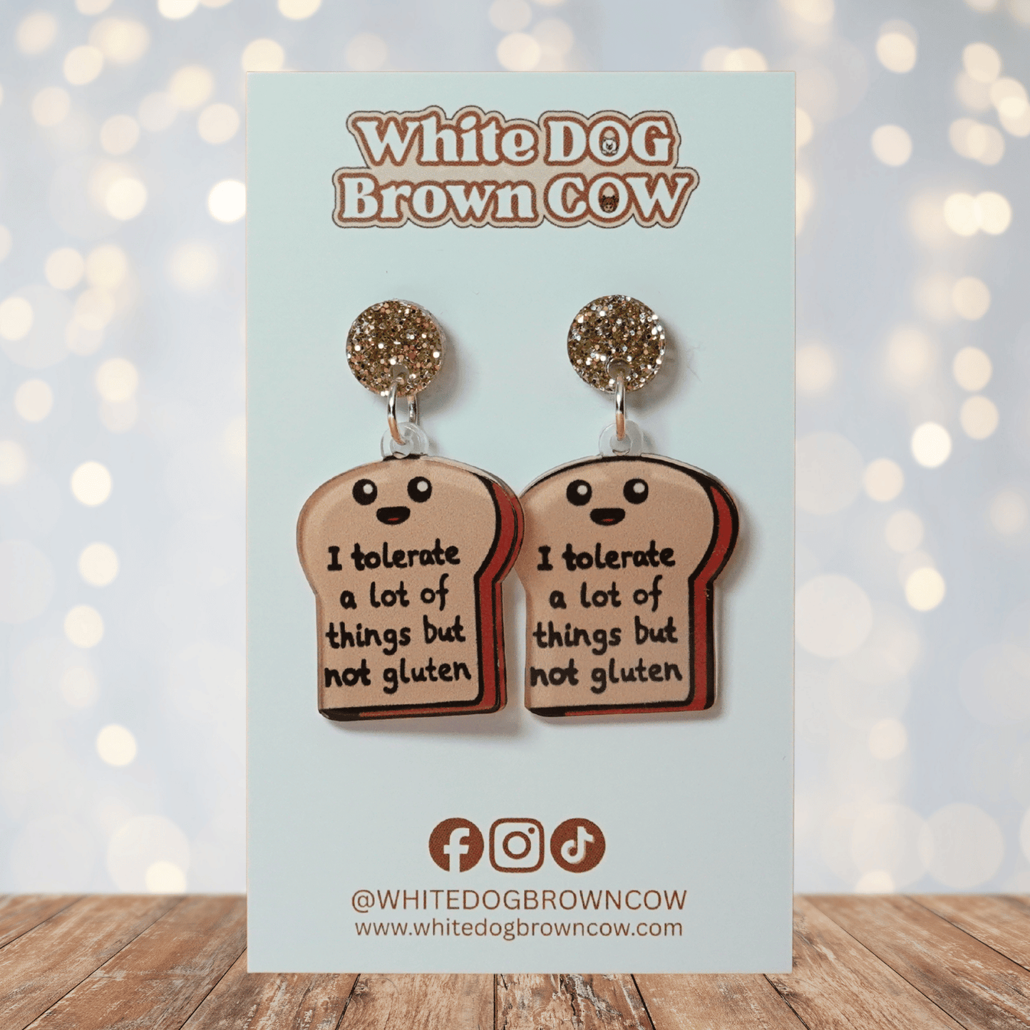 Acrylic dangle earrings shaped like a slice of bread with text reading “I tolerate a lot of things but not gluten”