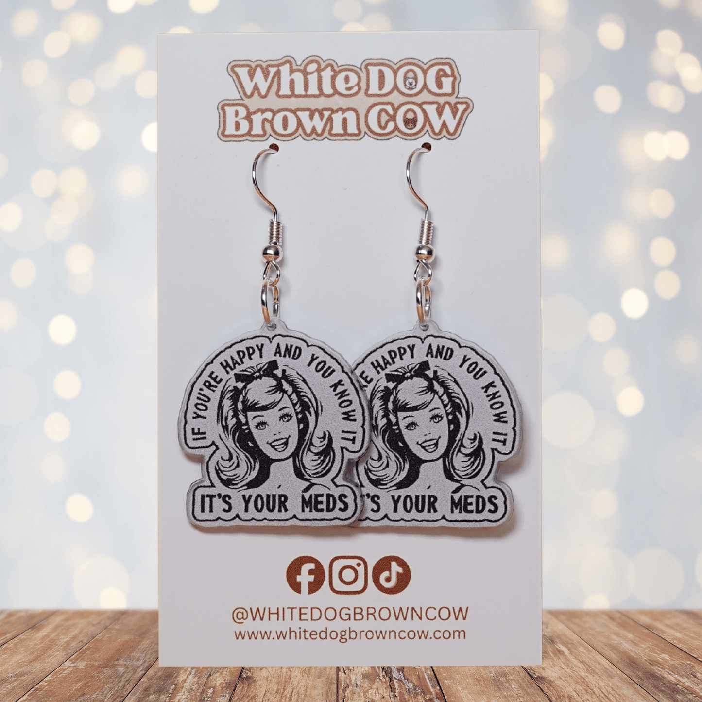 Black and white retro style earrings with woman illustration and text “If you’re happy and you know it it’s your meds”