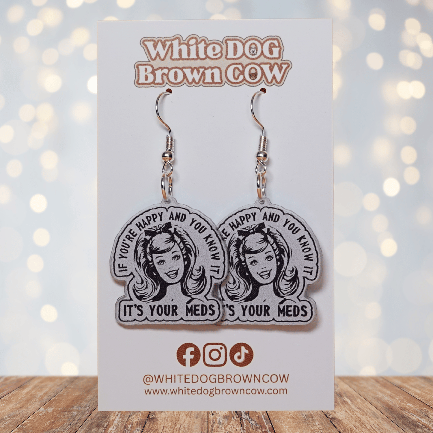 Black and white retro style earrings with woman illustration and text “If you’re happy and you know it it’s your meds”