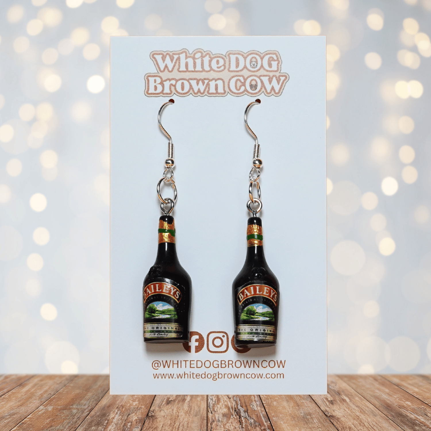 Mini Irish cream liqueur bottle shaped dangle earrings with dark bottle design and silver hooks.