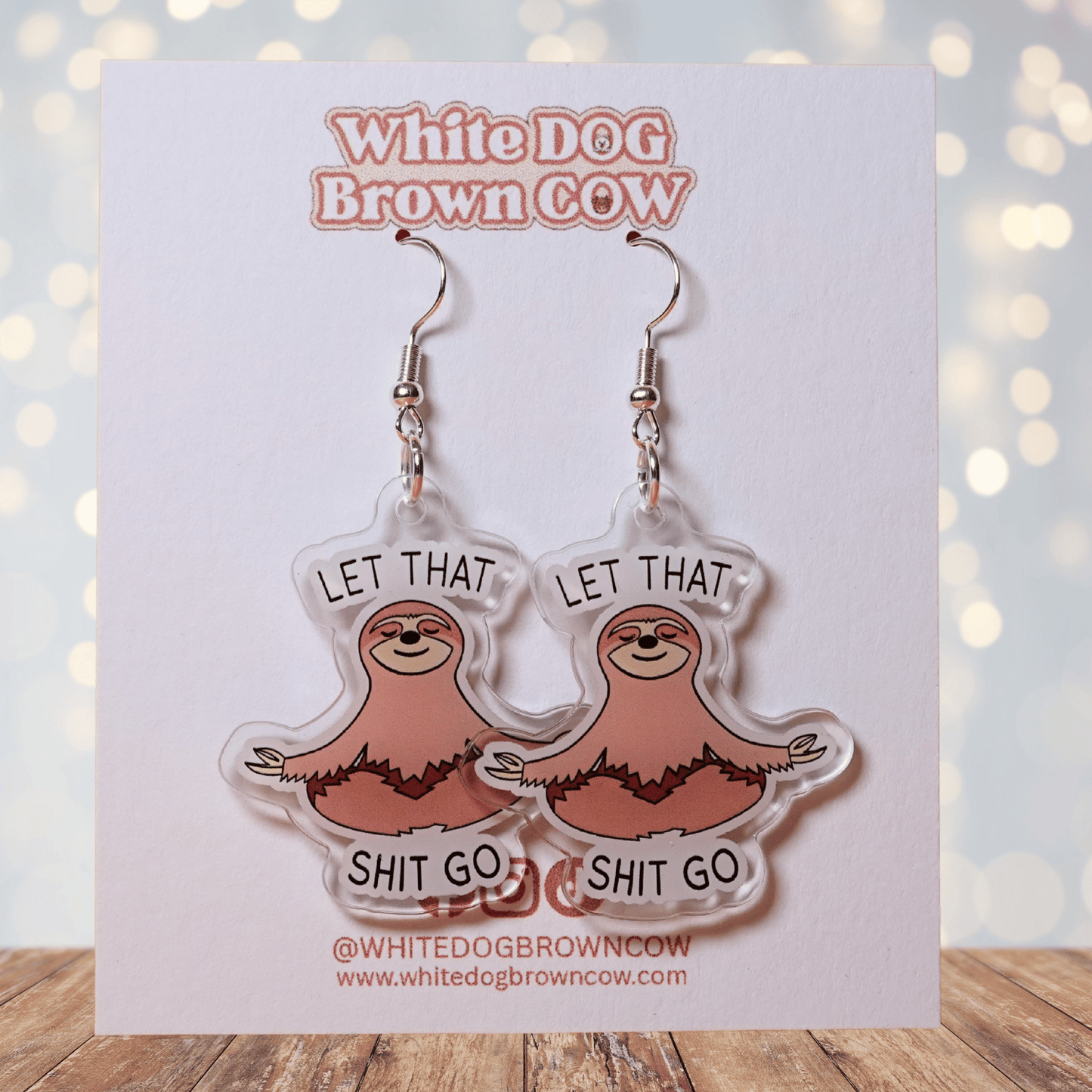 Cute sloth dangle earrings in meditation pose with text “let that shit go”