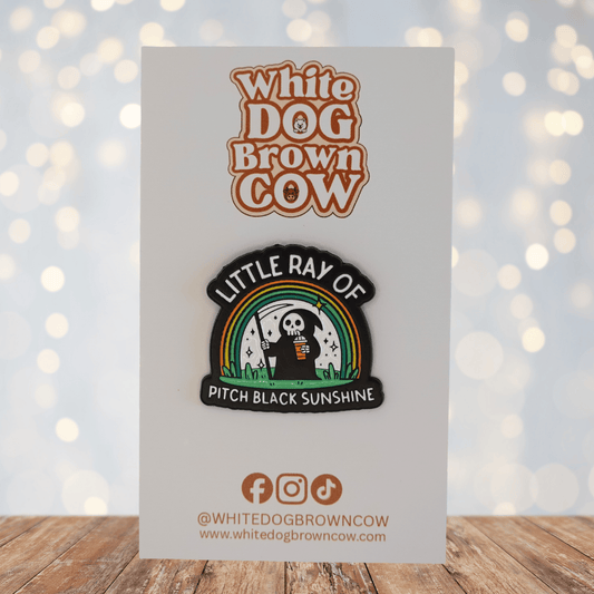 Funny grim reaper enamel pin under rainbow holding iced coffee with sarcastic pitch black sunshine quote