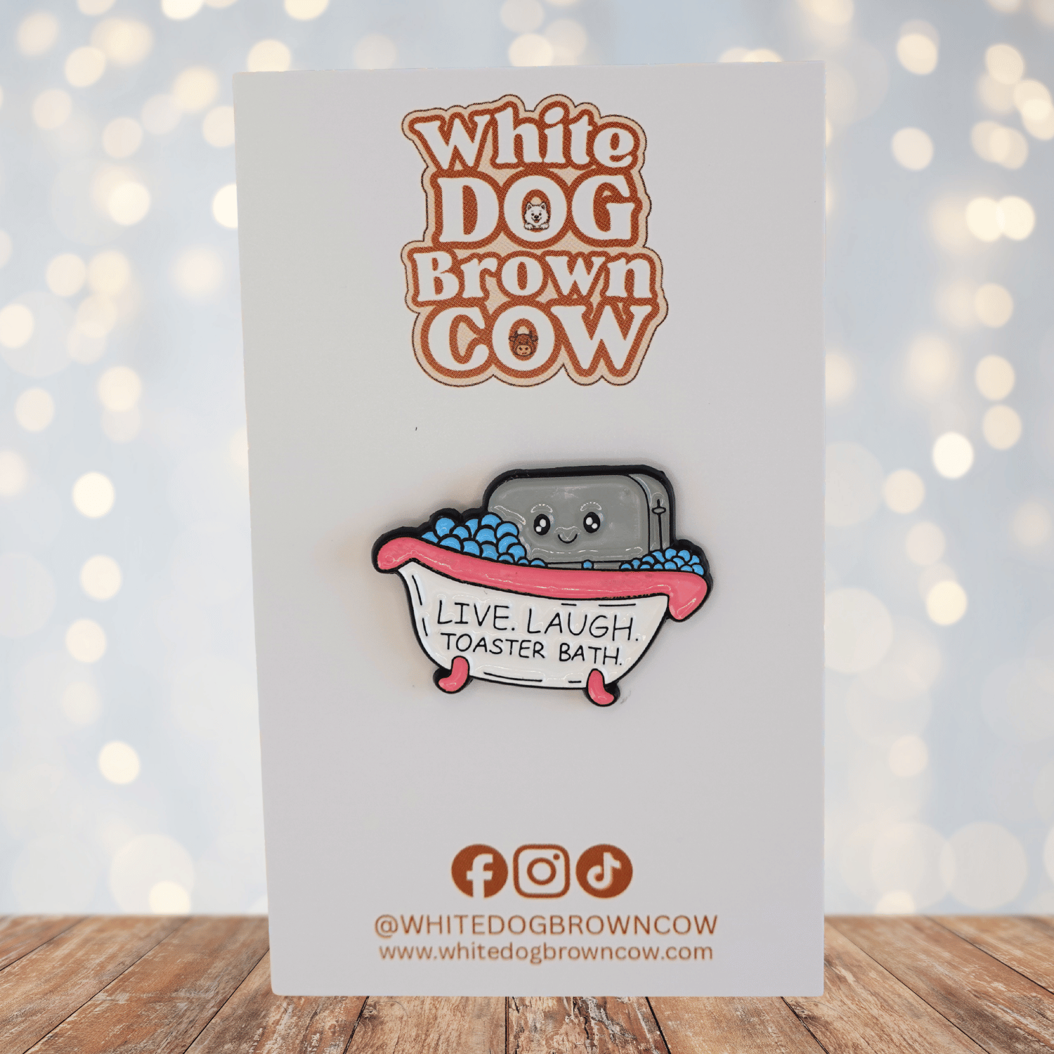 Funny dark humor enamel pin of smiling toaster in a bubble bath with text “live laugh toaster bath,” sarcastic novelty meme pin