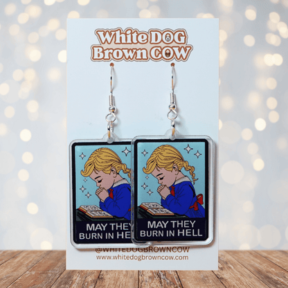 Clear acrylic dangle earrings with a vintage illustration of a praying girl and text reading “May they burn in hell”