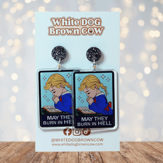 Clear acrylic dangle earrings with a vintage illustration of a praying girl and text reading “May they burn in hell”