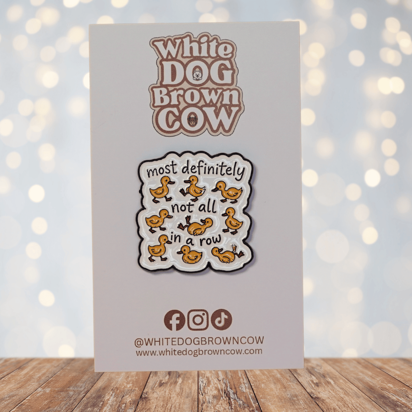 Funny sarcastic enamel pin with cartoon ducks and quote most definitely not all in a row