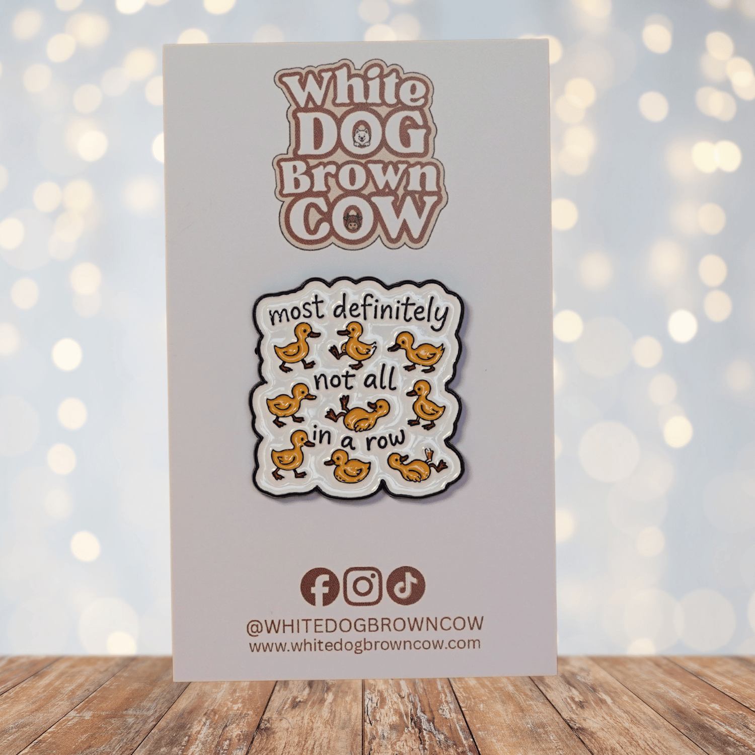 Funny sarcastic enamel pin with cartoon ducks and quote most definitely not all in a row