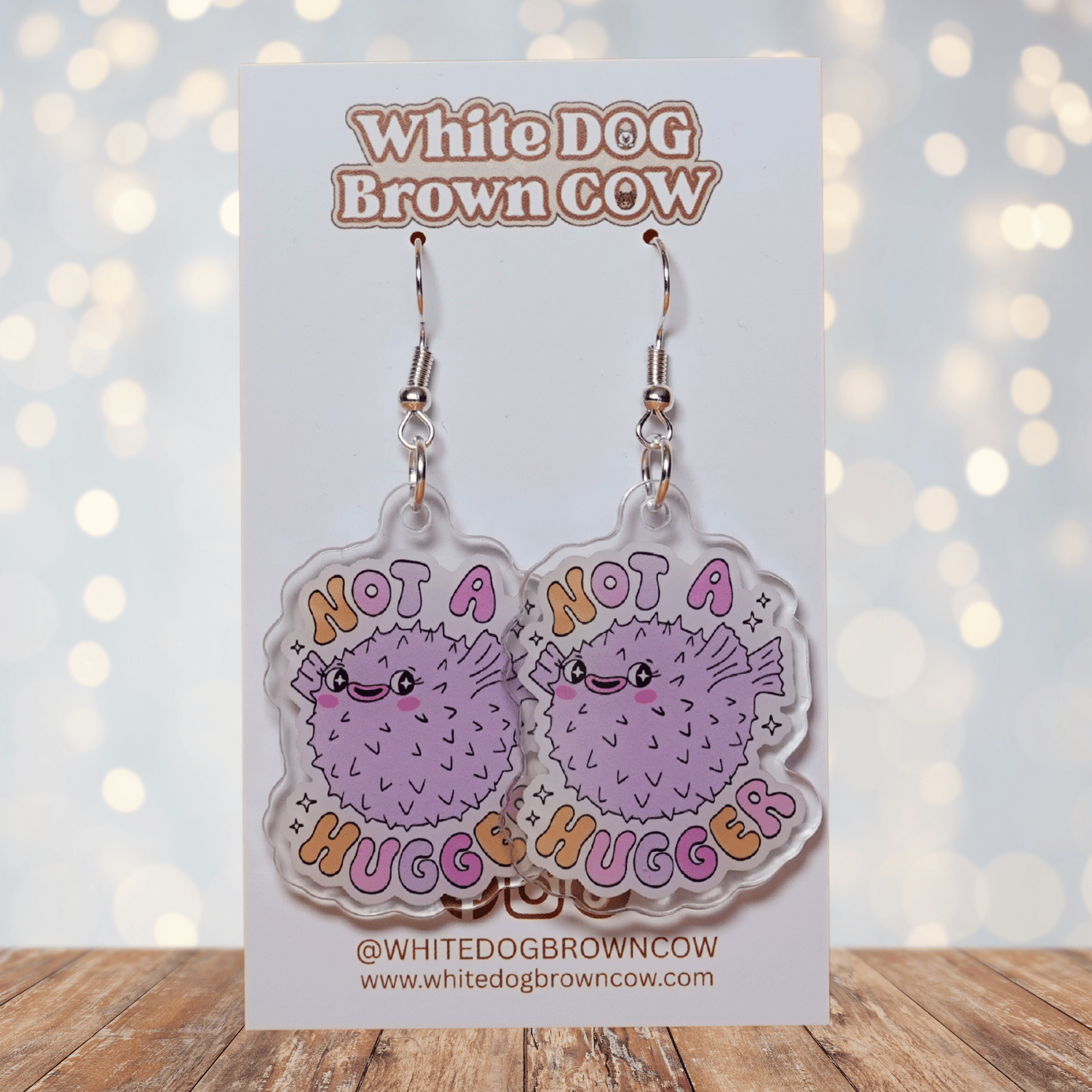 Cute pastel pufferfish dangle earrings with text “Not a Hugger”