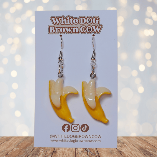 Cute dangle earrings shaped like partially peeled bananas with a realistic yellow and cream design.