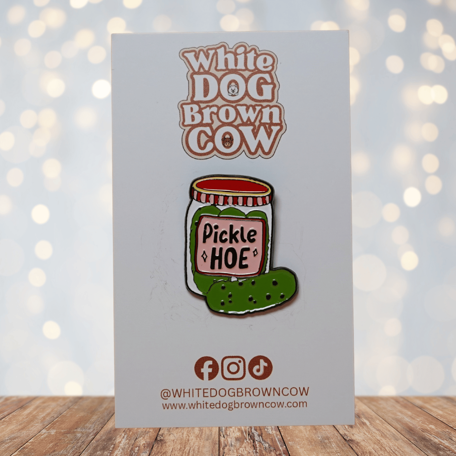 Cute enamel pin of a pickle jar labeled “Pickle Hoe” with green pickle illustration, funny food pun lapel pin.