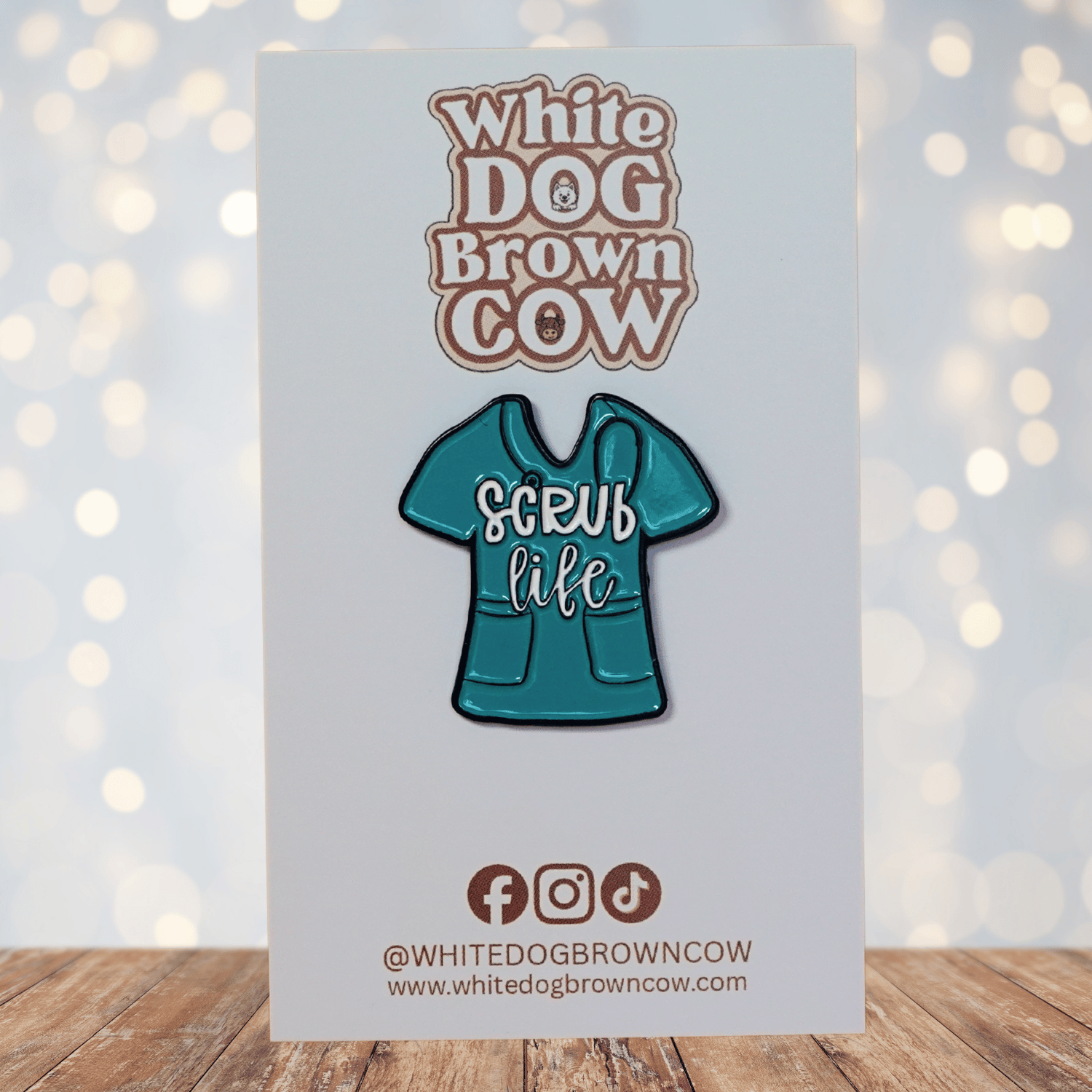 Funny “Scrub Life” enamel pin shaped like teal medical scrubs for nurses and healthcare workers