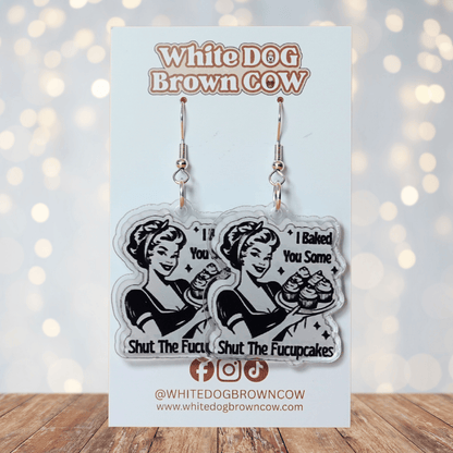 Retro style novelty dangle earrings with a vintage woman holding cupcakes and the phrase “I baked you some shut the fucupcakes”